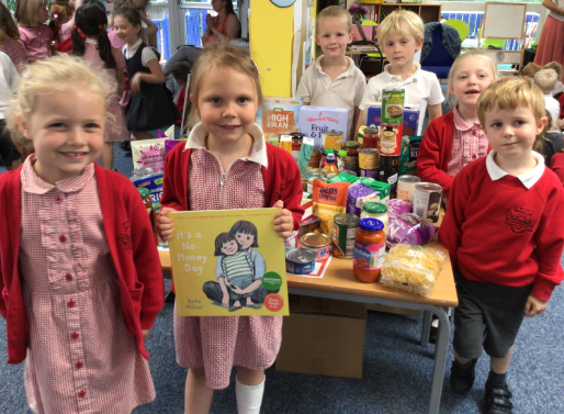 Chidlren with books and food bank donations.