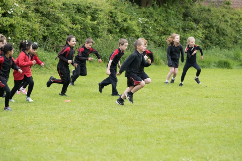 Children racing in the field.