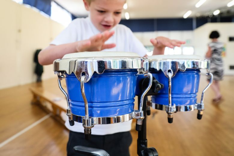 A child playing bongo drums.